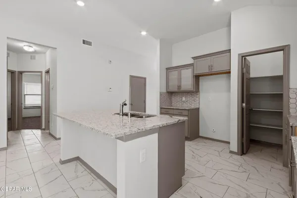 a kitchen with a sink cabinets and window