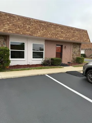 a kitchen with kitchen island granite countertop a stove a sink and a microwave
