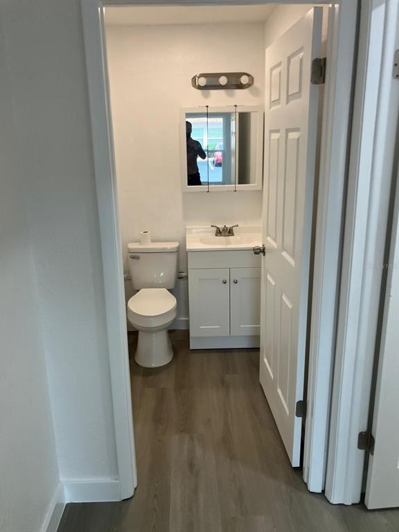 6125 Chesham Drive, Unit 1 New Port Richey, FL 34653 - Photo 27 of 39 a bathroom with a toilet sink and a mirror