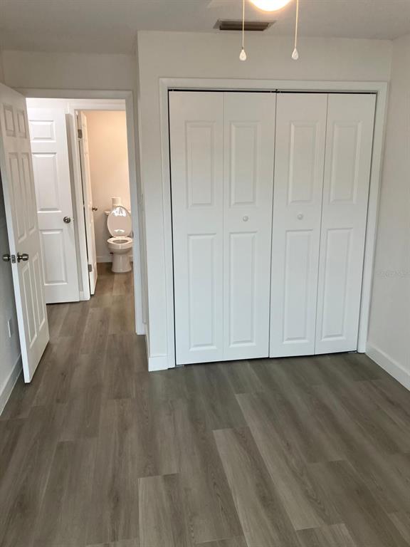 6125 Chesham Drive, Unit 1 New Port Richey, FL 34653 - Photo 33 of 39 a view of an empty room with wooden floor