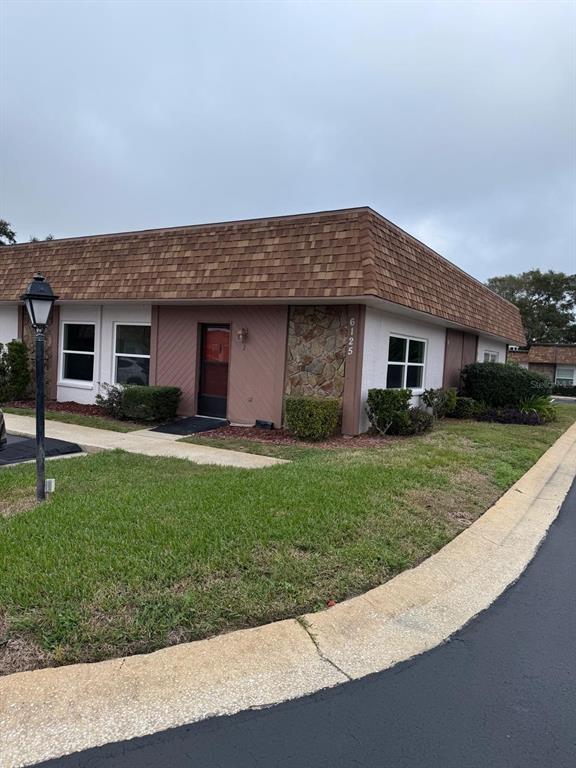 6125 Chesham Drive, Unit 1 New Port Richey, FL 34653 - Photo 39 of 39 a backyard of a house with lots of green space