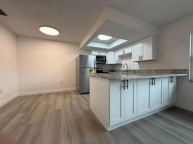 a view of an empty room and a window