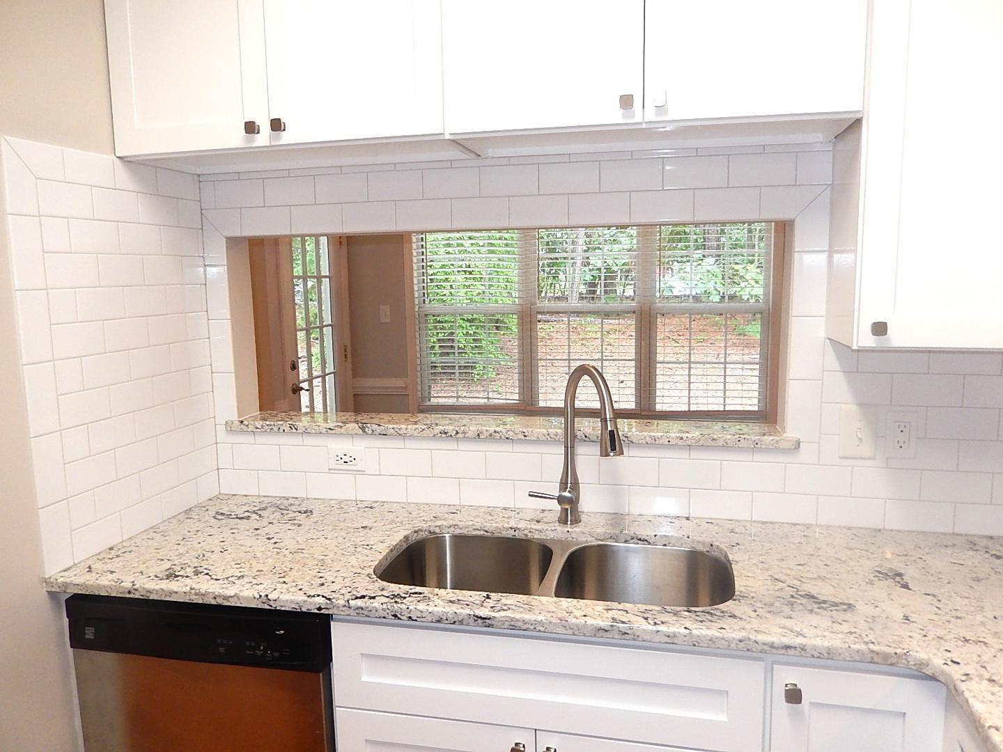 211 Bridgepath Drive Cary, NC 27513 - Photo 12 of 26 a kitchen with granite countertop a sink and a window