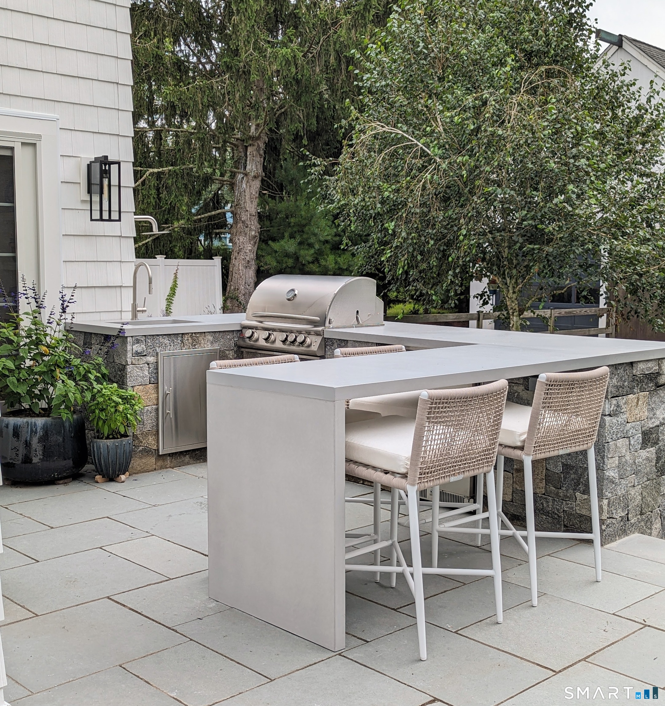 85 Garnet Park Road Madison, CT 06443 - Photo 32 of 40 a patio with a dinning table and chairs