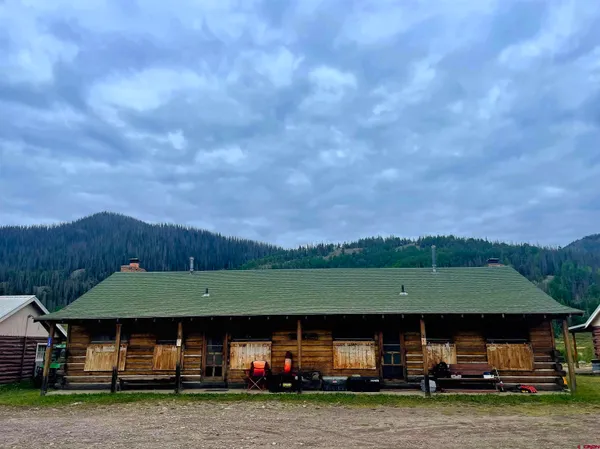 a view of house with a garden and car parked