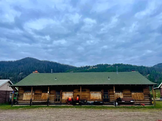 a view of house with a garden and car parked