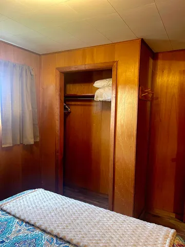 a bedroom with a bed and a wooden door