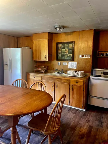 a kitchen with a table chairs and a refrigerator