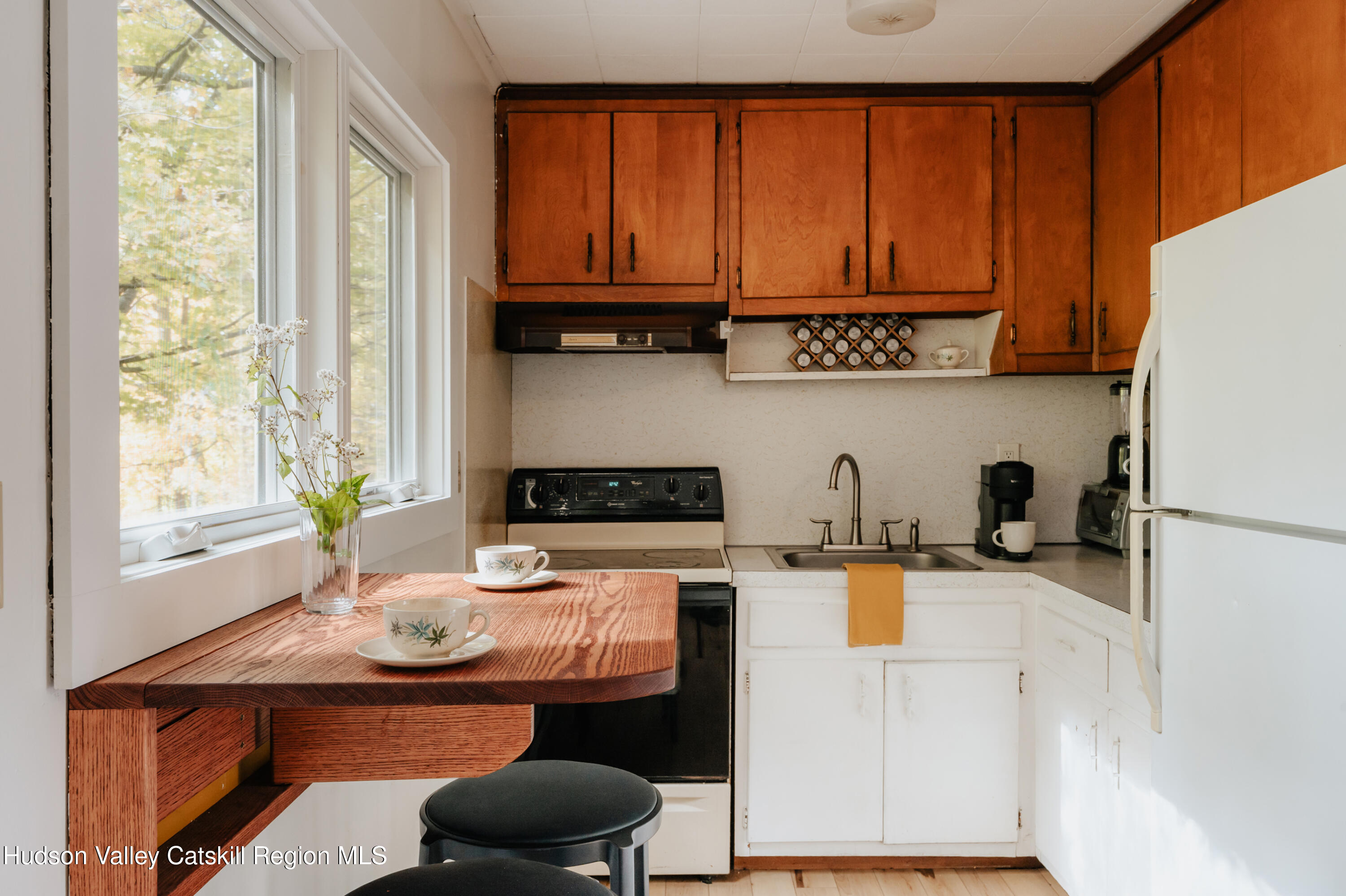 782-784 Jackson Corners Road Red Hook, NY 12571 - Photo 47 of 63 a kitchen with stainless steel appliances a white refrigerator a sink a stove and wooden cabinets