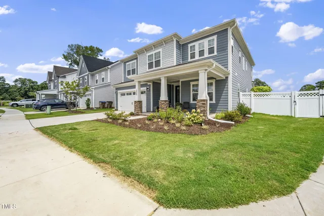 a view of a house with a swimming pool and a yard