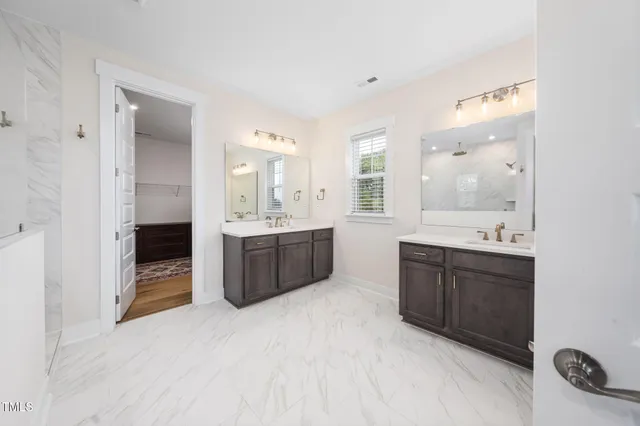 a bathroom with a granite countertop sink a toilet and a mirror