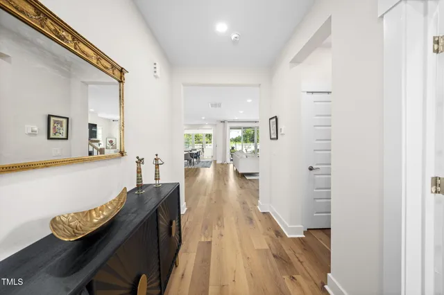 a large white kitchen with a large window and stainless steel appliances