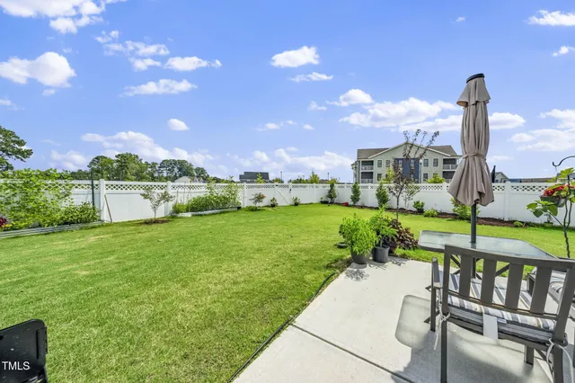 a front view of a house with a yard and outdoor seating