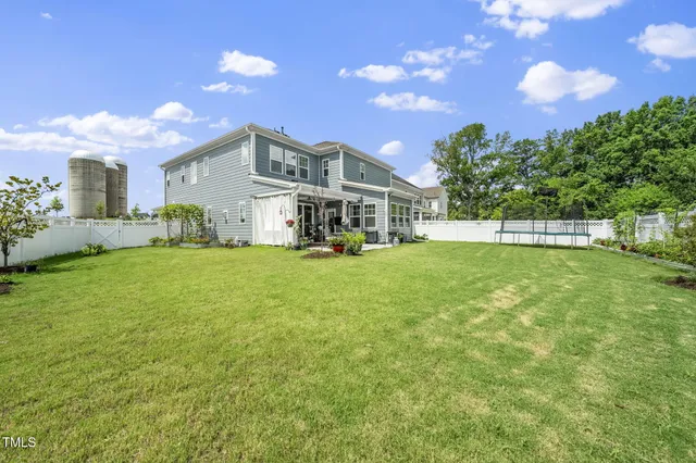 a view of a house with a yard and sitting area