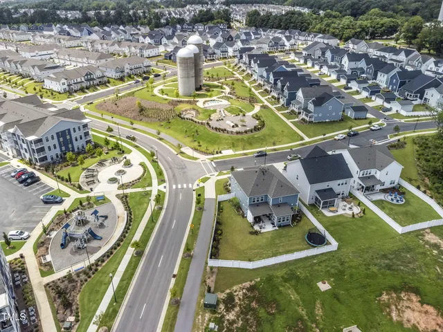 an aerial view of a swimming pool with a yard and mountain view