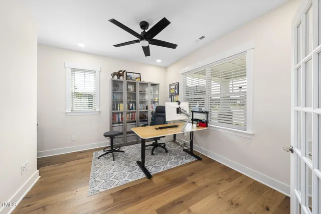 a living room with furniture a fireplace a flat screen tv and a large window