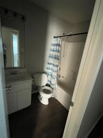 a living room with a couch and a potted plant