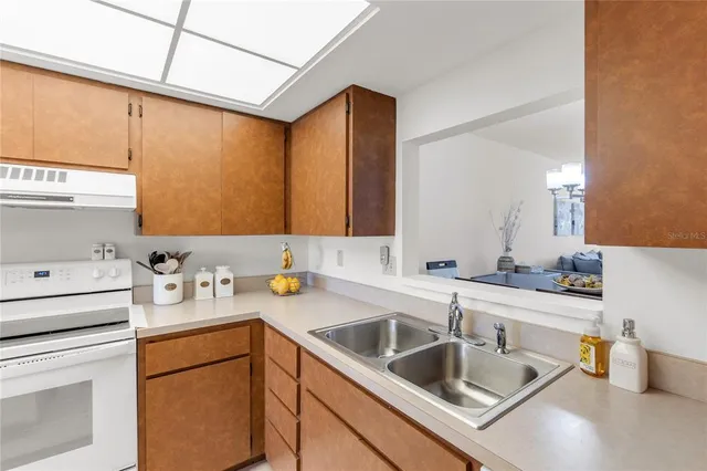 a kitchen with a sink stove and cabinets