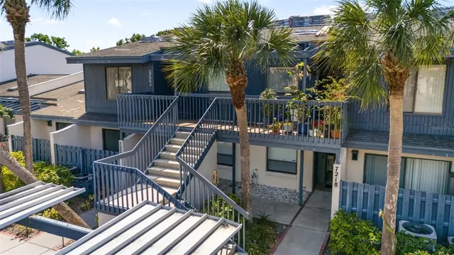 a view of a house with backyard and deck