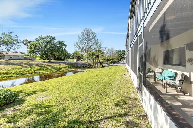 a view of a swimming pool with a garden and trees