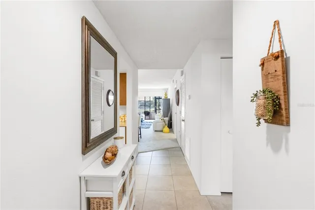 a view of a hallway with wooden floor and a bathroom