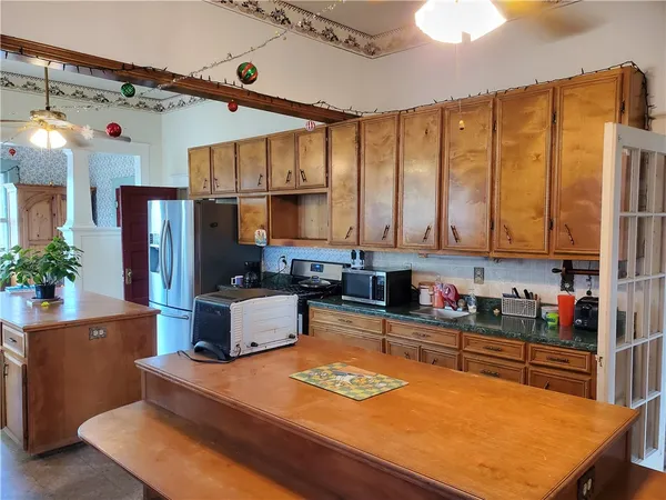 a kitchen with stainless steel appliances a refrigerator sink and cabinets