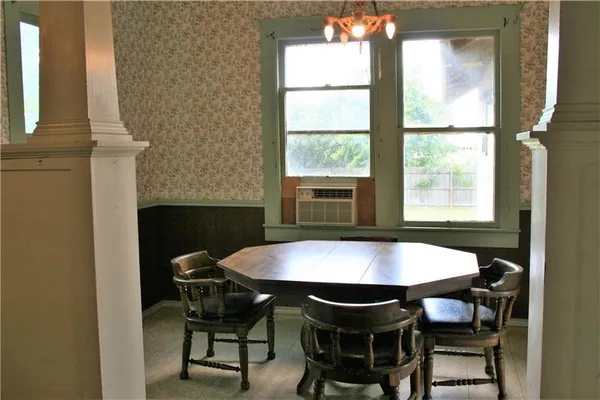 a view of a dining room with furniture and window
