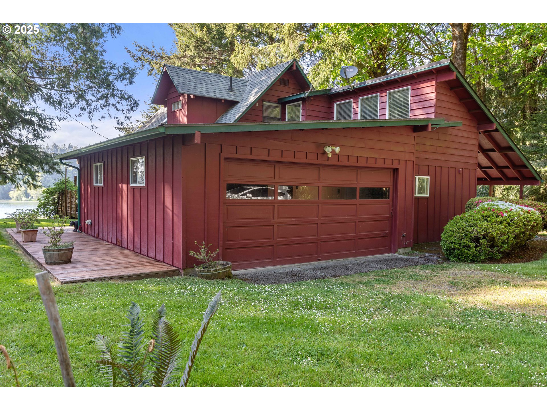83049 Siltcoos Station Road Westlake, OR 97493 - Photo 12 of 48 a front view of a house with garden