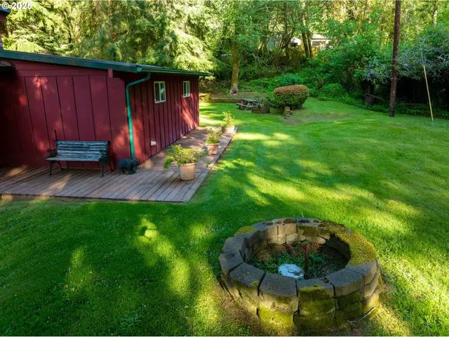 a view of backyard with outdoor seating and green space