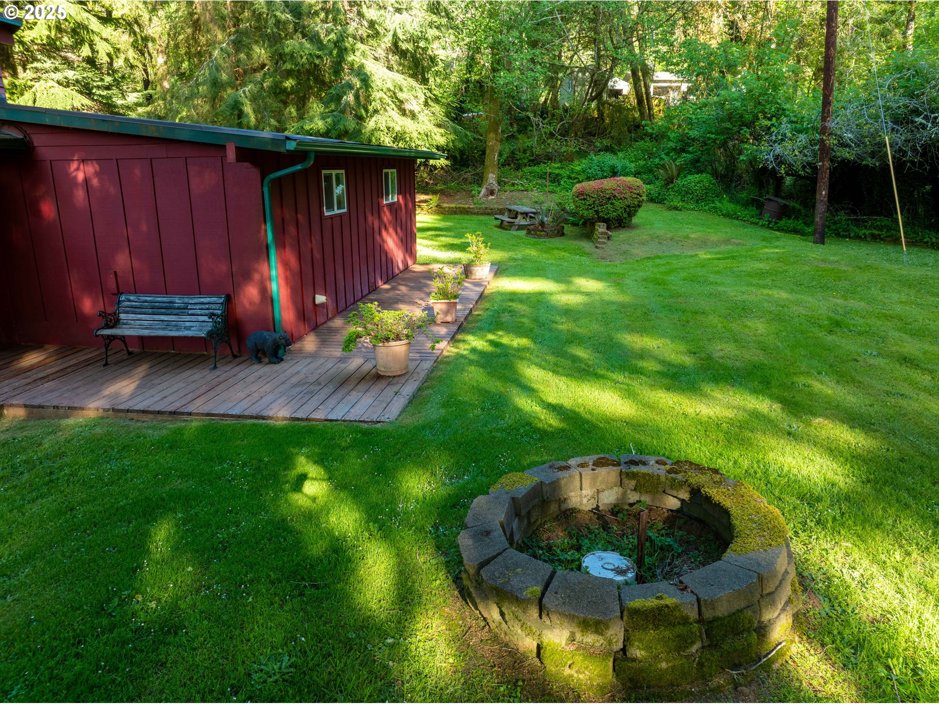 83049 Siltcoos Station Road Westlake, OR 97493 - Photo 16 of 48 a backyard of a house with yard and outdoor seating