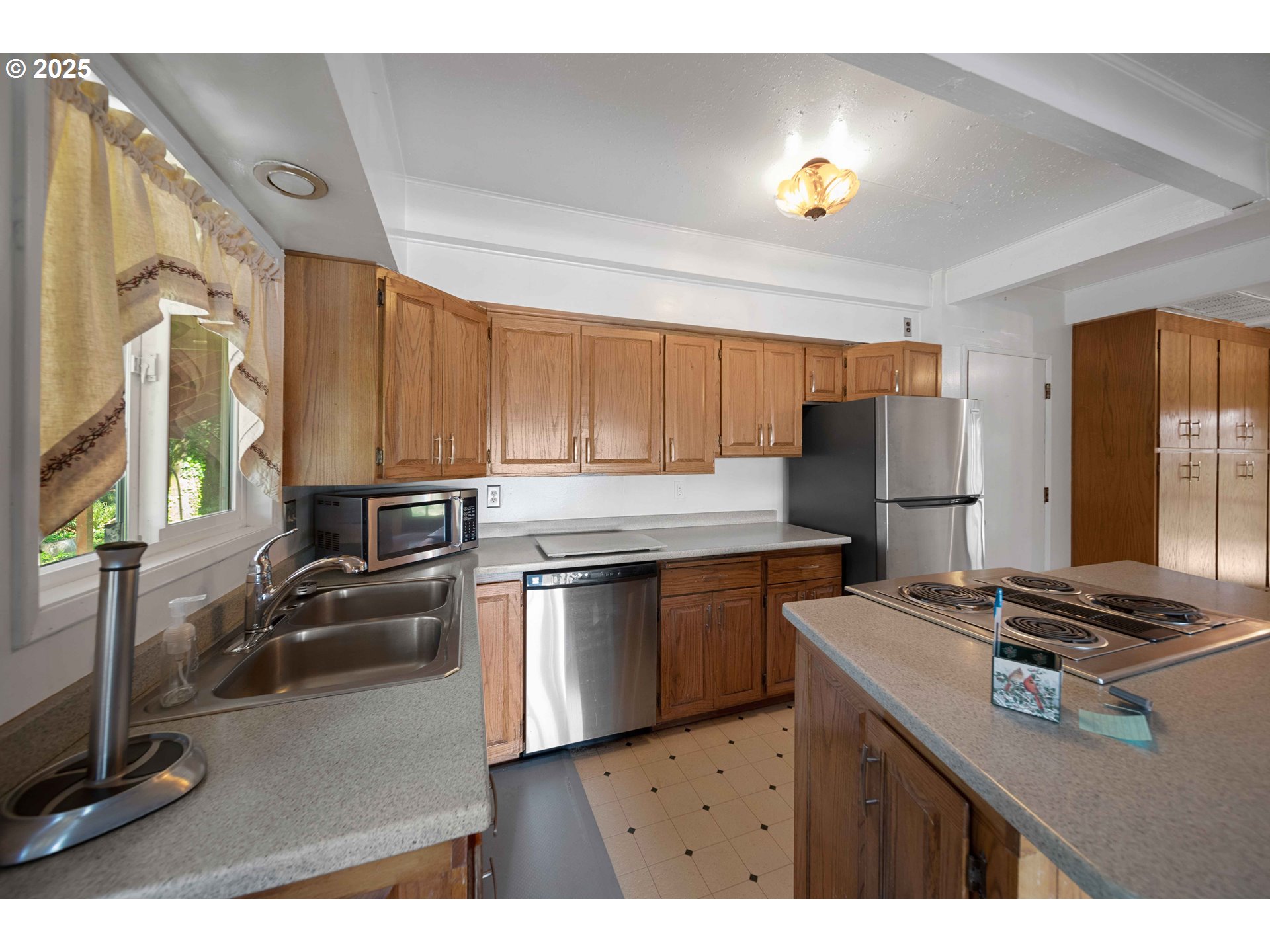 83049 Siltcoos Station Road Westlake, OR 97493 - Photo 22 of 48 a kitchen with a refrigerator and a stove