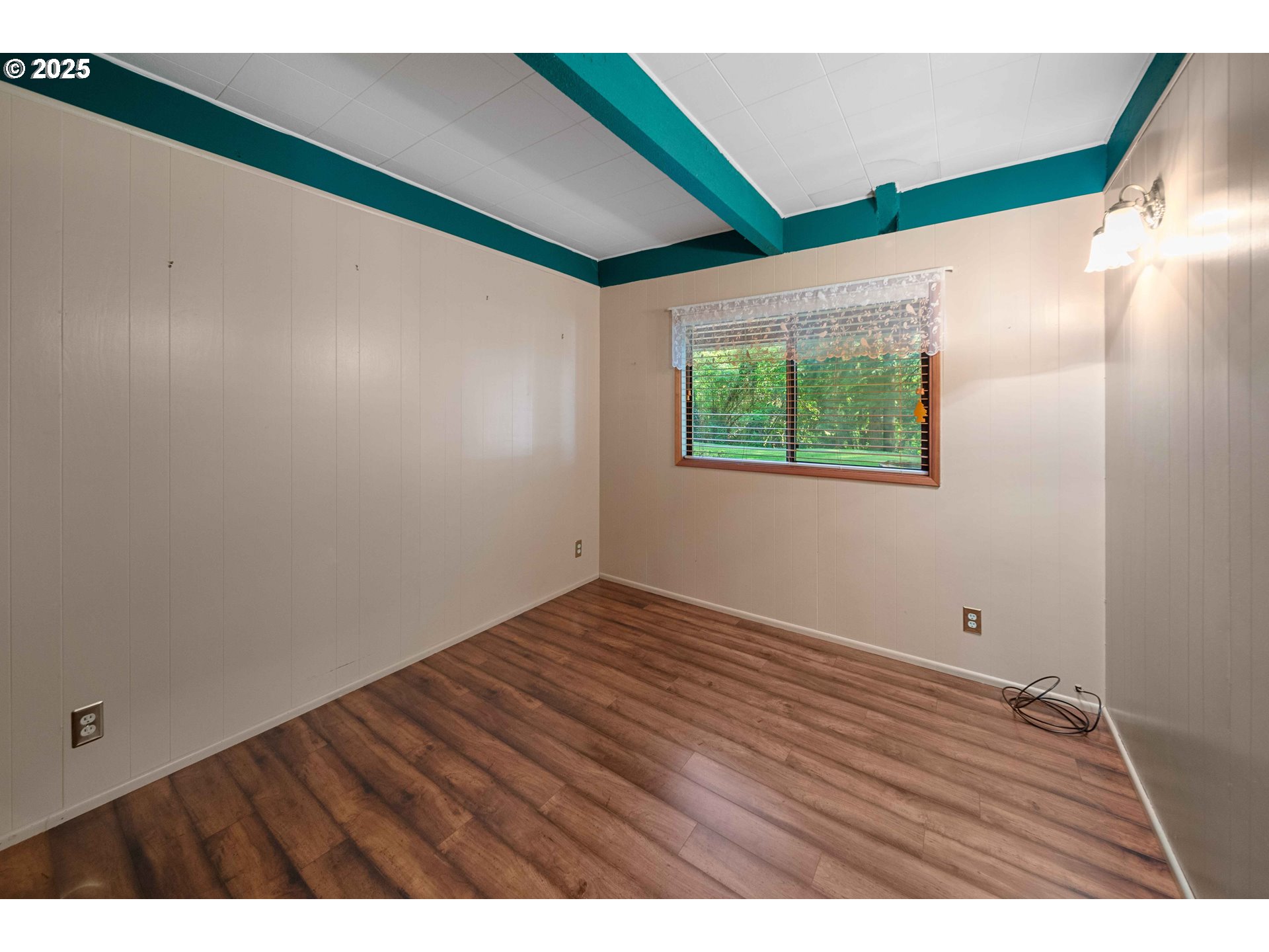 83049 Siltcoos Station Road Westlake, OR 97493 - Photo 29 of 48 a view of an empty room with wooden floor and a window