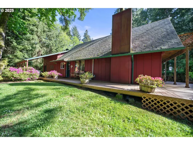 a view of house with garden and tall trees