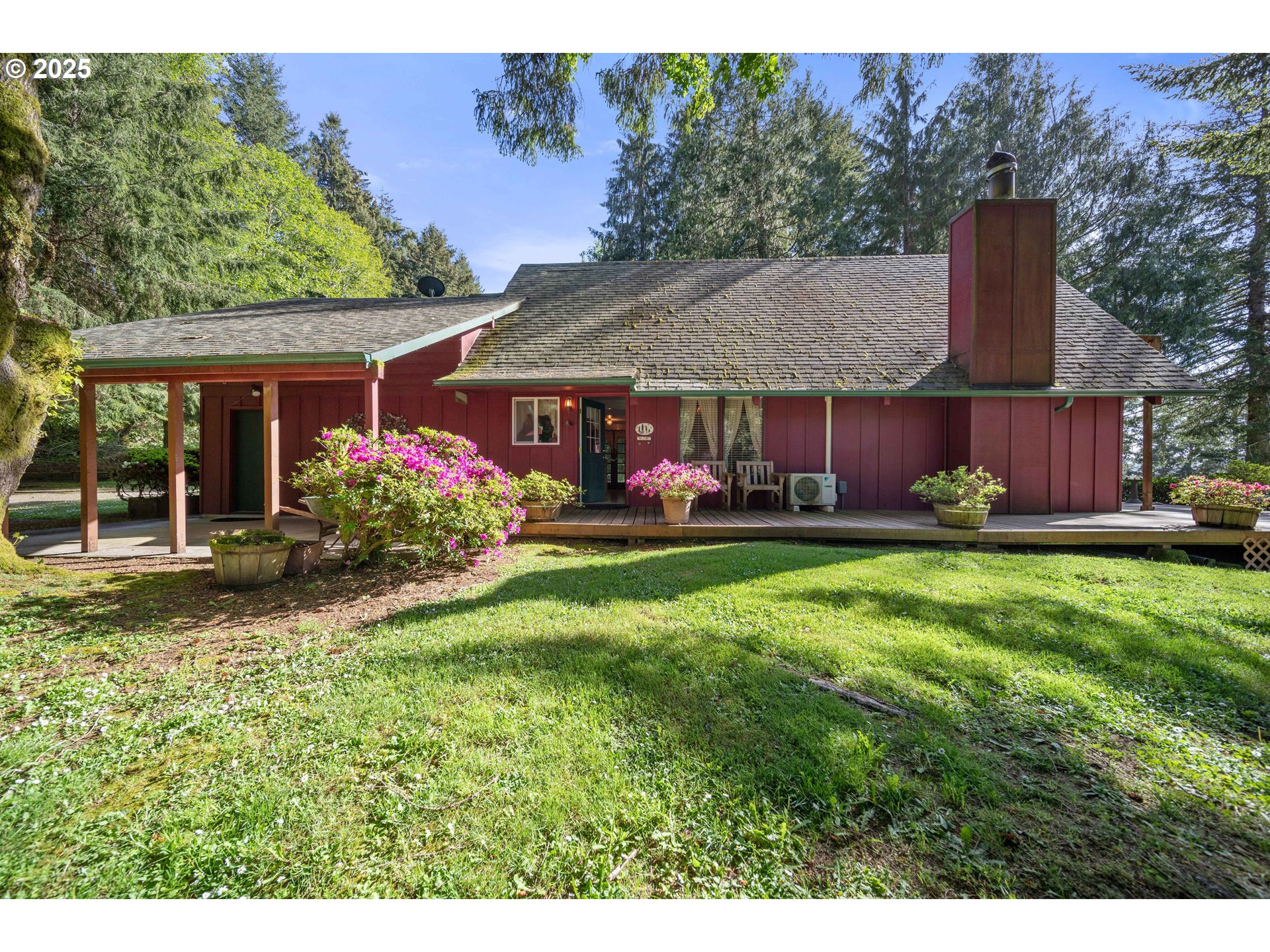 83049 Siltcoos Station Road Westlake, OR 97493 - Photo 9 of 48 a view of house with garden and tall trees