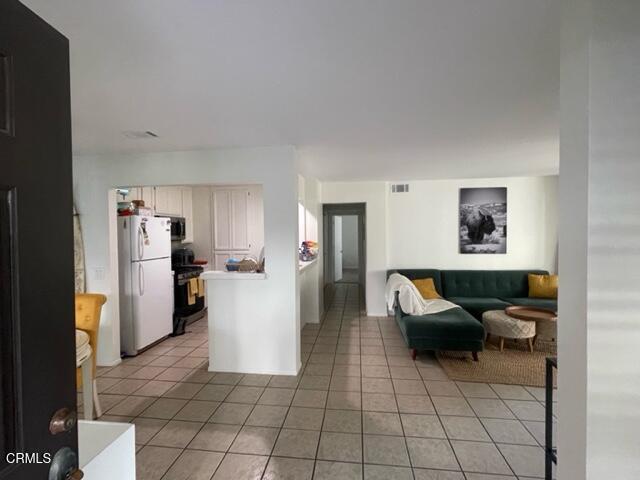 4455 Antigua Way Oxnard, CA 93035 - Photo 15 of 26 a living room with furniture and a refrigerator