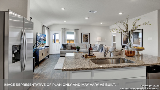 1008 Village Run Seguin, TX 78155 - Photo 18 of 39 a kitchen with stainless steel appliances granite countertop a sink refrigerator and cabinets