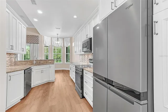 a view of a room with wooden floor and a window