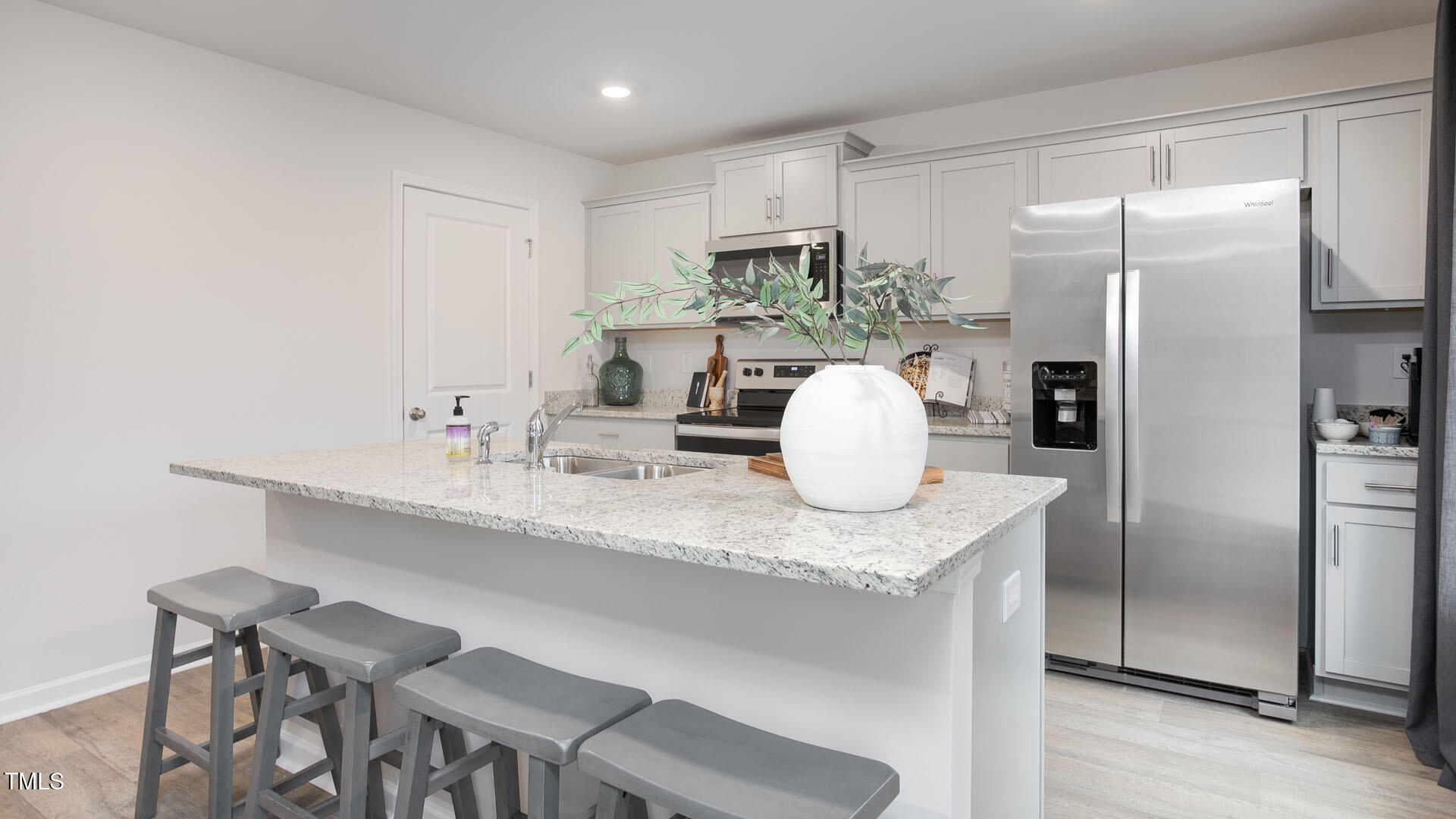 5901 Sodium Street Raleigh, NC 27610 - Photo 6 of 23 a kitchen with stainless steel appliances granite countertop a sink refrigerator and microwave
