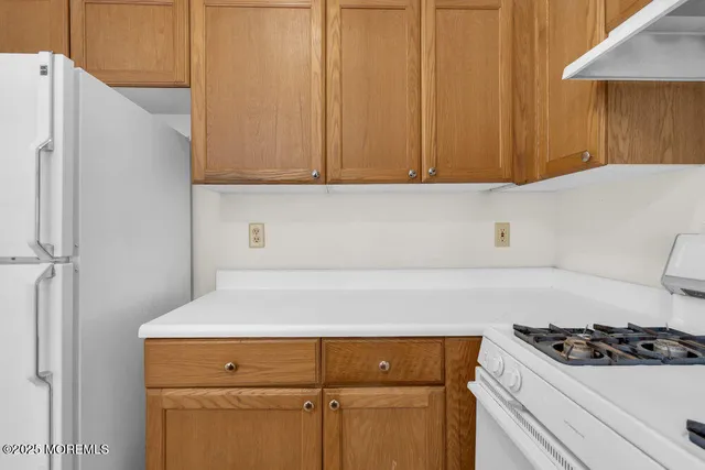 a kitchen with a sink and a refrigerator