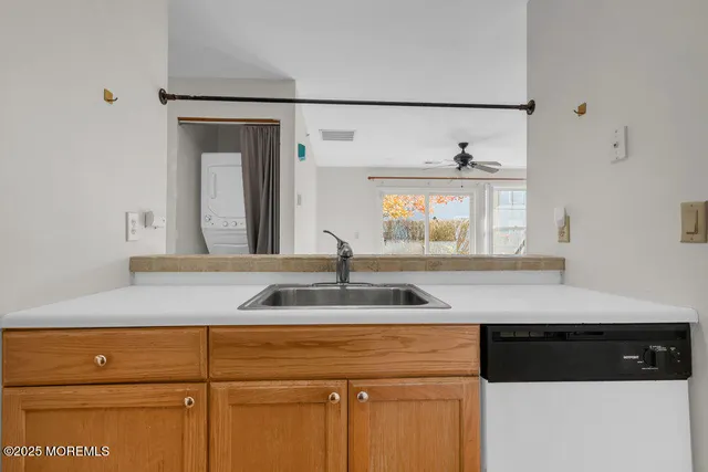 a utility room with sink dryer and washer
