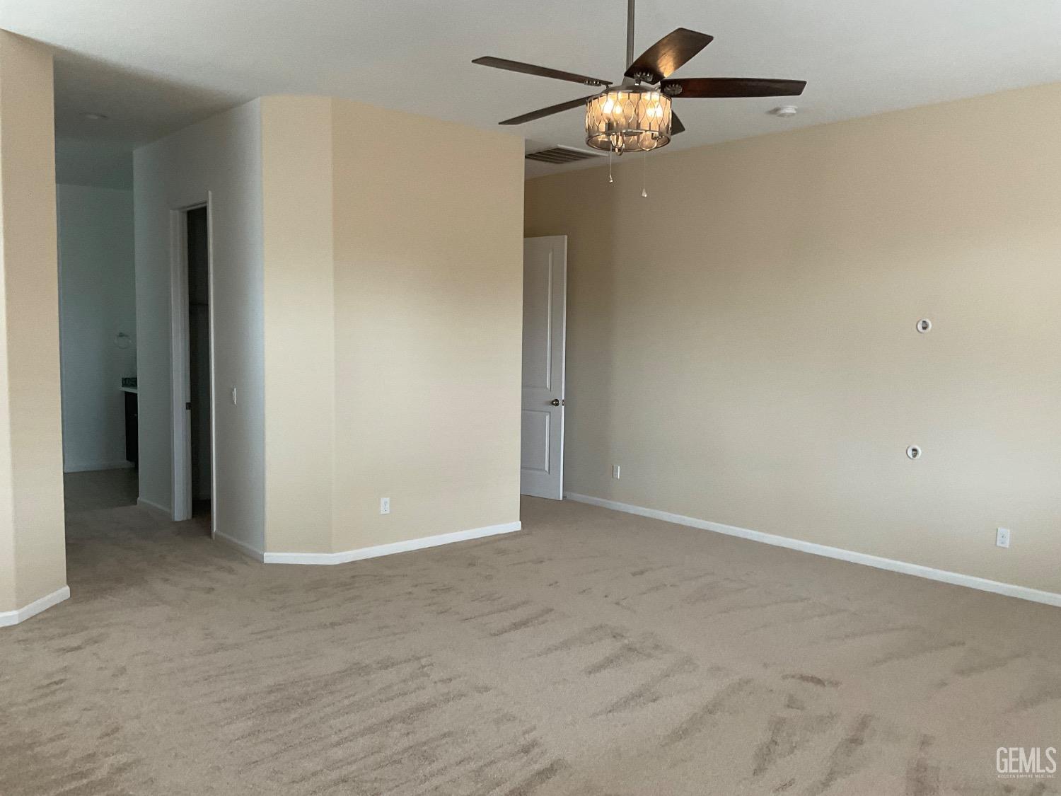 Undisclosed Address Bakersfield, CA 93314 - Photo 14 of 31 an empty room with closet and a chandelier fan