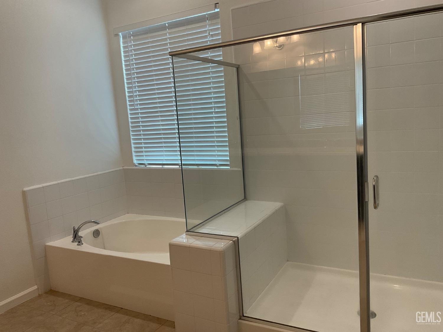 Undisclosed Address Bakersfield, CA 93314 - Photo 16 of 31 a bathroom with a bathtub and shower