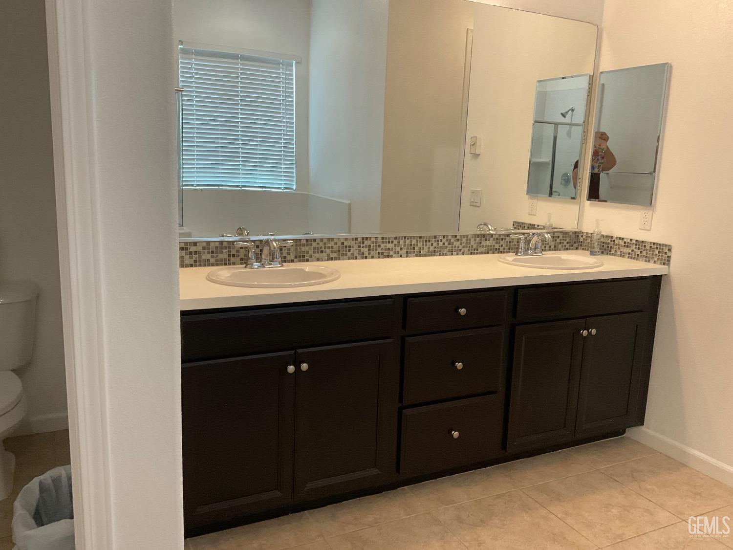 Undisclosed Address Bakersfield, CA 93314 - Photo 17 of 31 a bathroom with a sink and a mirror