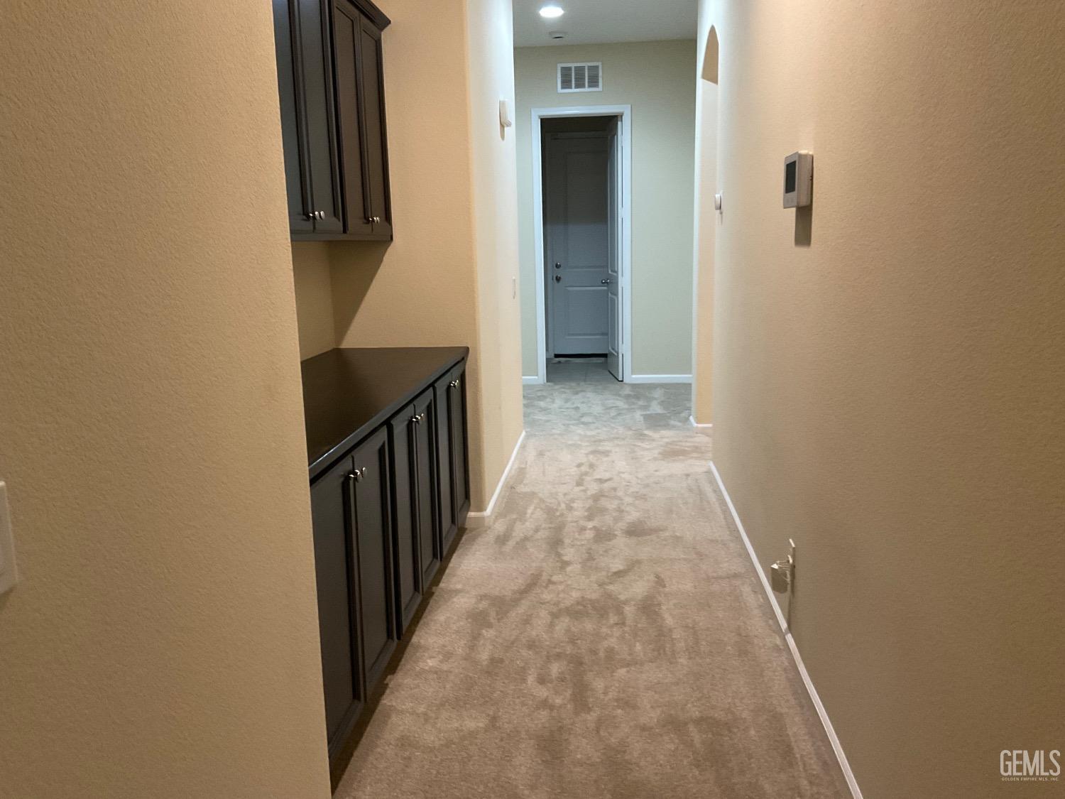 Undisclosed Address Bakersfield, CA 93314 - Photo 19 of 31 a view of a hallway with wooden floor and staircase