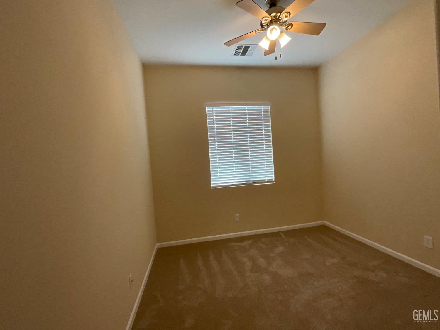 Undisclosed Address Bakersfield, CA 93314 - Photo 20 of 31 an empty room with a window and a fan