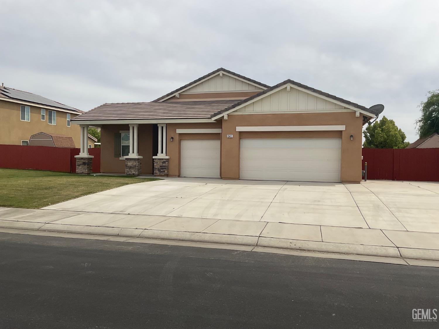 Undisclosed Address Bakersfield, CA 93314 - Photo 2 of 31 a front view of a house with a yard and garage
