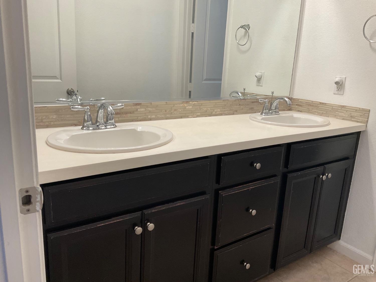 Undisclosed Address Bakersfield, CA 93314 - Photo 21 of 31 a bathroom with a sink and a mirror