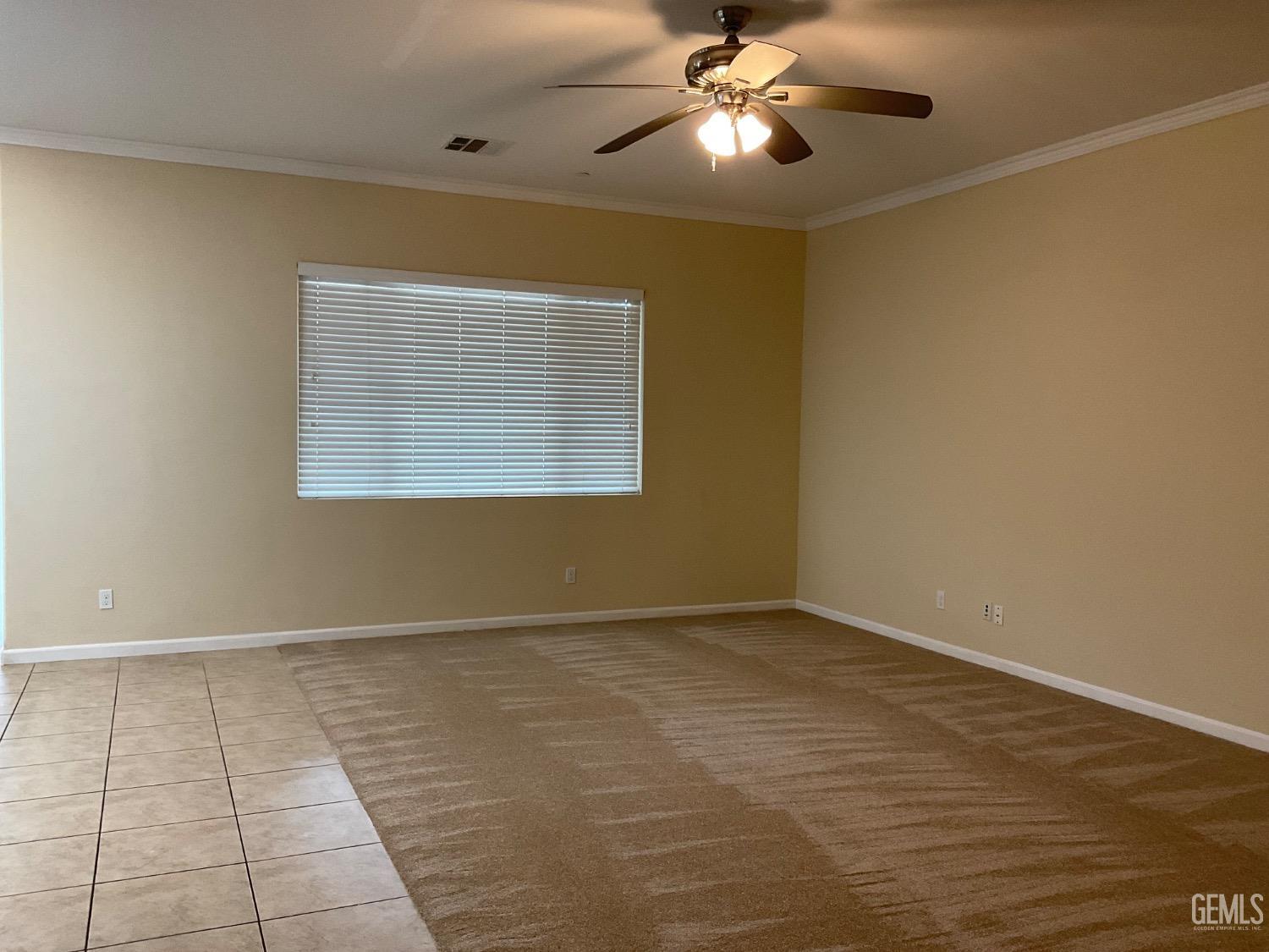 Undisclosed Address Bakersfield, CA 93314 - Photo 7 of 31 an empty room with windows and fan