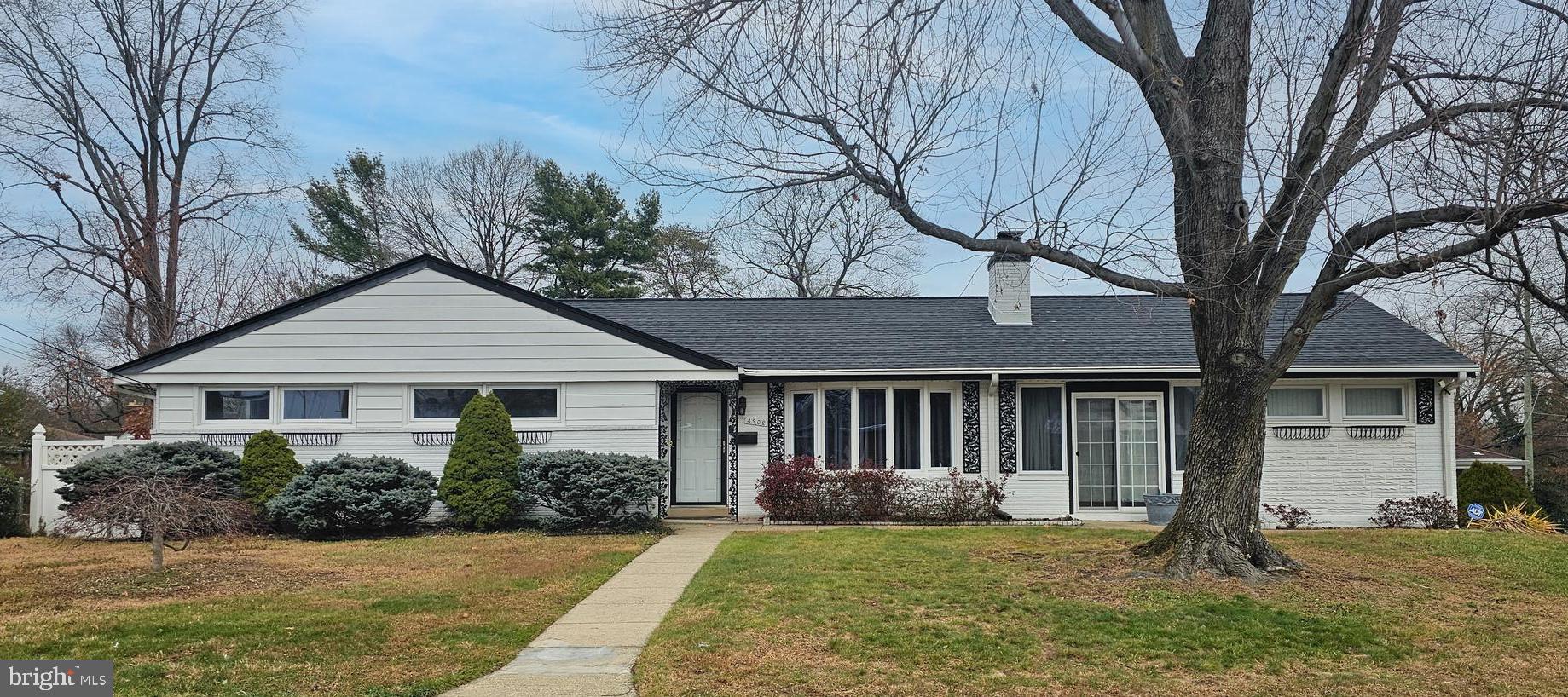 a house that has a tree in front of it
