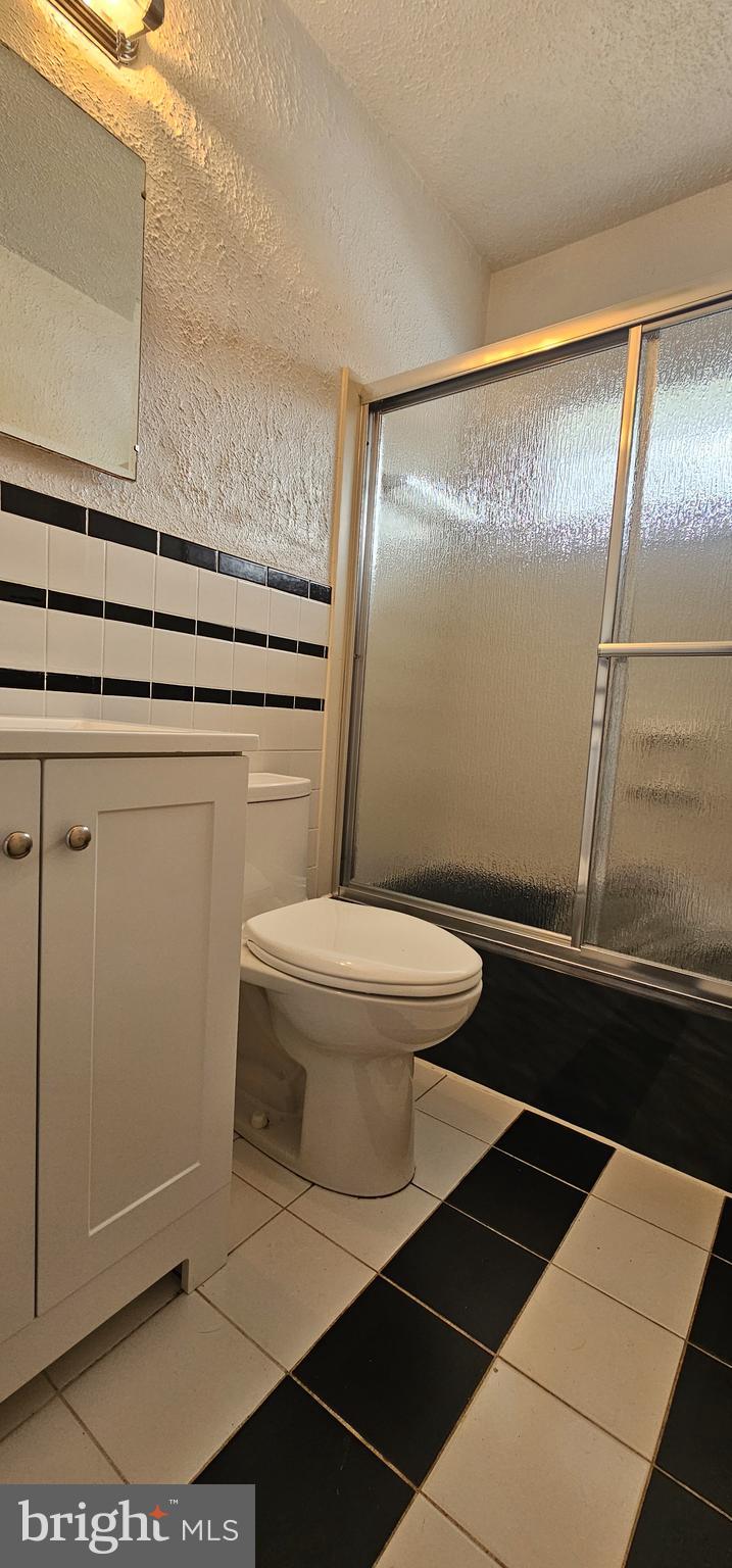 4202 Yates Road Beltsville, MD 20705 - Photo 9 of 35 a bathroom with a sink a toilet a mirror and shower